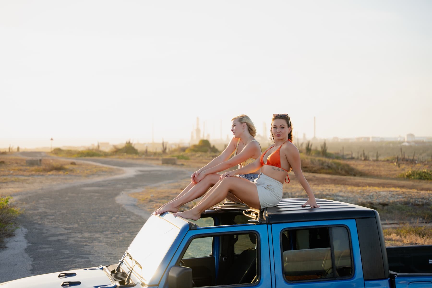 Friends on a Jeep roof at sunset