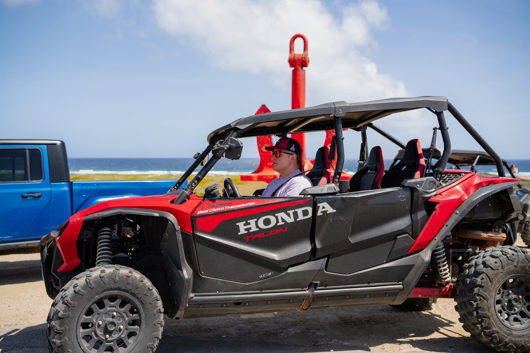 A guest at the wheel of a Honda Talon UTV on Aruba's north coast