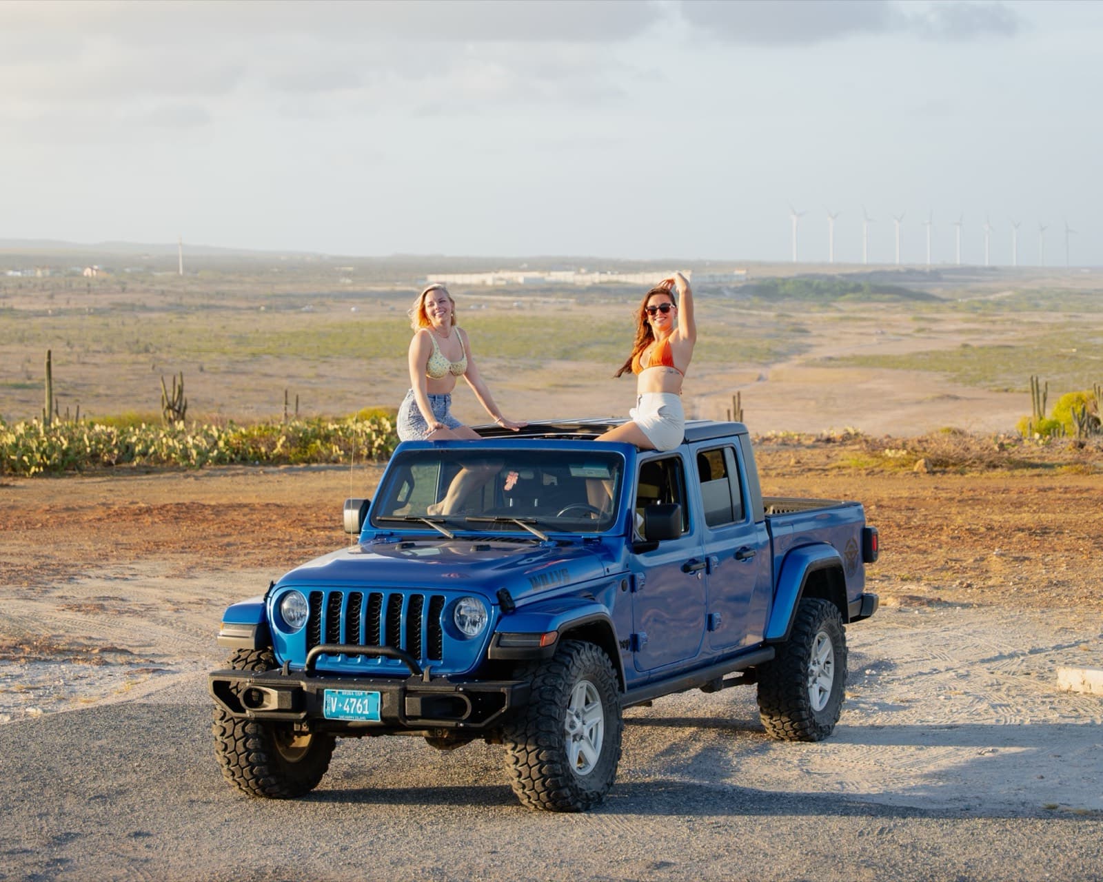 Guests on a Jeep Gladiator overlooking the windmill valley